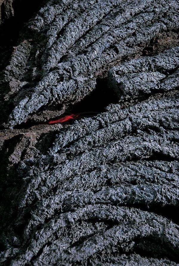 Collection EM, titled "Lava Eye", year 1998. Etna eruption in 1998, lava string,  effusive lava to the mouth (detail), slide 1/8, 30x45, cibachrome slide by direct printing, 40x55 forex 10mm, white Contouring , cardboard, edges coating volcanic sand