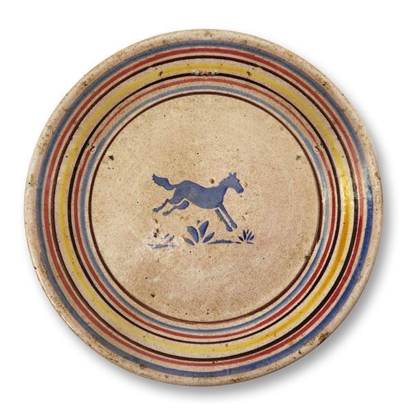 Caltagirone majolica plate decorated in polychrome with a running horse in the centre