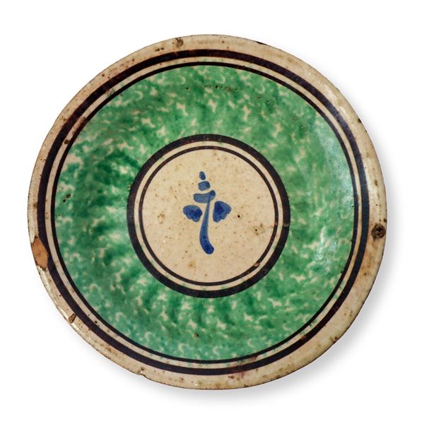 Caltagirone plate sponged green and decorated in the center with a flower