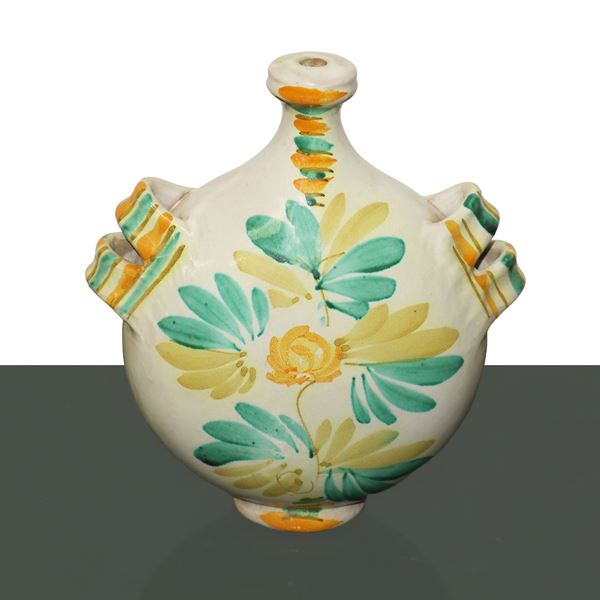 Caltagirone majolica water bottle, glazed and enamelled in polychrome, decorated with vine shoots