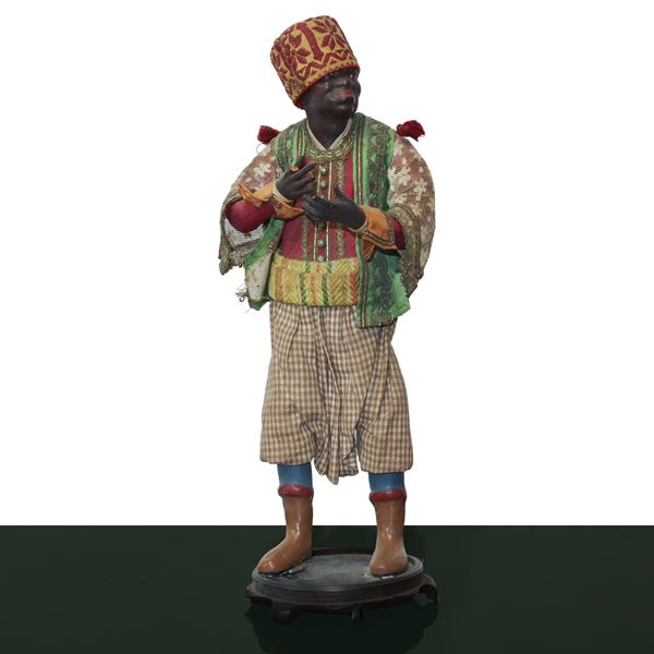 Nativity scene character in terracotta and wood with cotton, satin and trimmings clothes: dark-haired servant