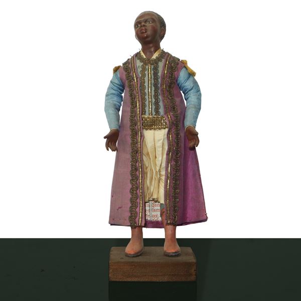 Nativity scene character in terracotta and wood with cotton, satin and trimmings clothes: dark-haired child