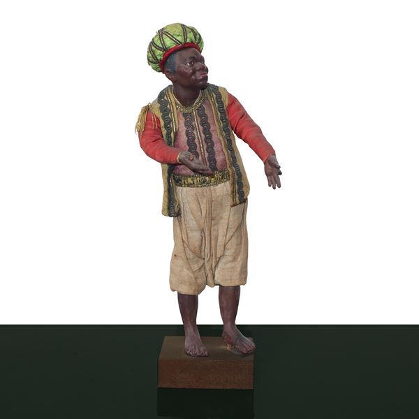Nativity scene character in terracotta and wood with cotton, satin and trimmings clothes: dark-haired servant with turban 