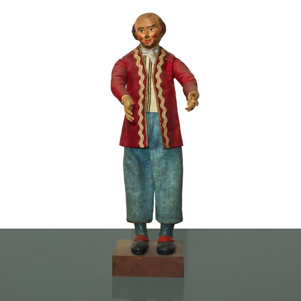 Nativity scene character in terracotta and wood with cotton, satin and trimmings clothes: bald man with pink jacket and white scarf