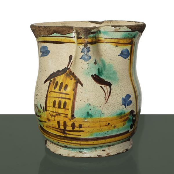 Cannata in Caltagirone majolica glazed and enameled in polychrome with a house on the front 