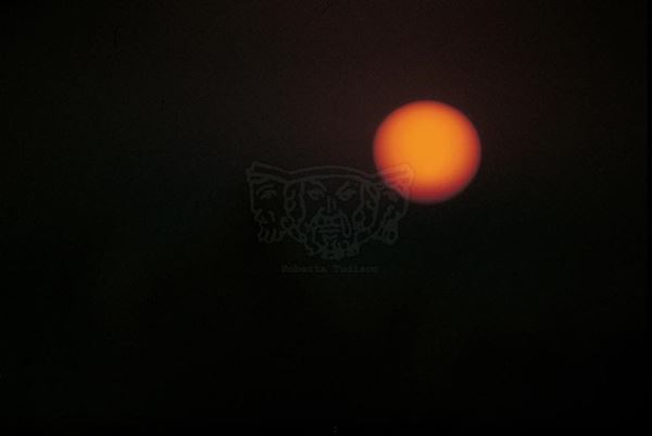 EM Collection, titled "Sun", 2001. Porto Palo: arncione sunset with sun and dark sky, slide 1/8, 30x45, Cibachrome print directly from the slide, 40x55 forex 10mm, Contouring white, cardboard, cover edges volcanic sand