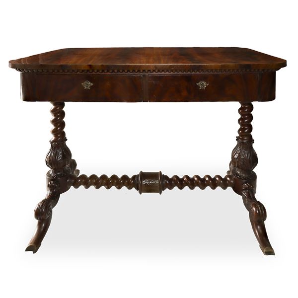 Mahogany feather desk, two drawers. Feet carved with acanthus leaves connected to a torchon