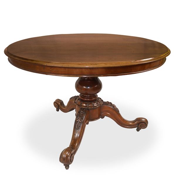 Extendable round dining table in mahogany wood with three-spoke base carved and sculpted with leaves 