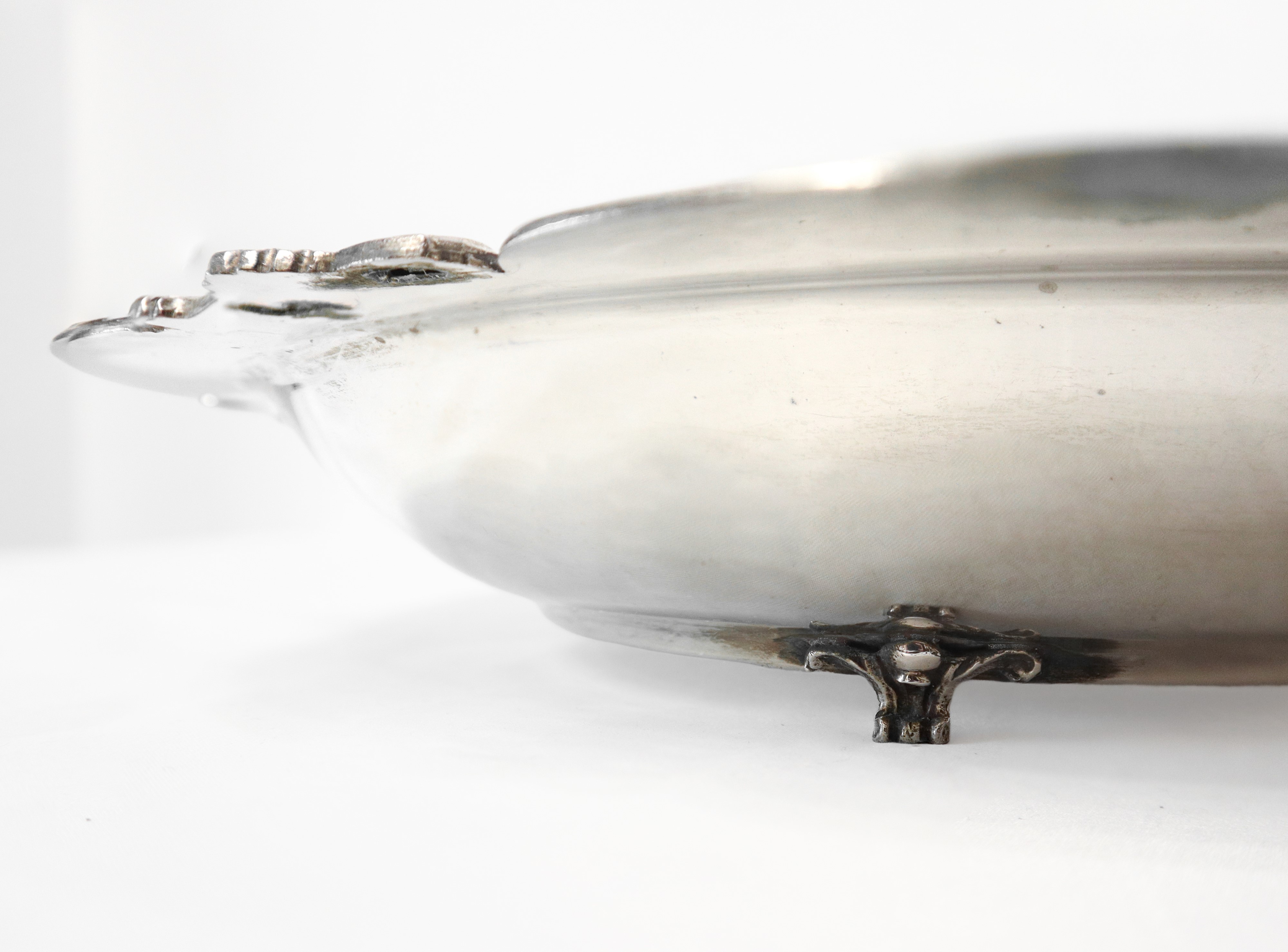 Centrotavola in argento 800 con piedi di sostegno leonino e bordo decorato a conchiglie