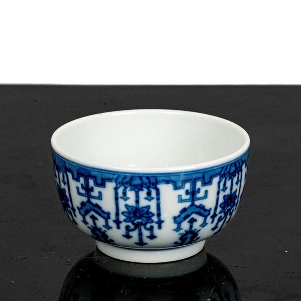 Small blue and white cup