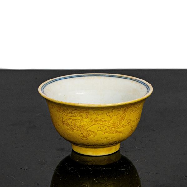 Small yellow bowl with engraved decorations