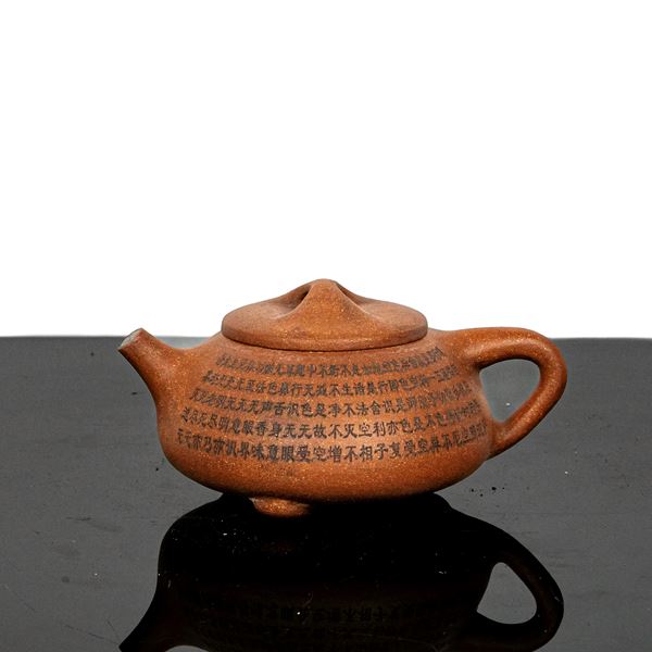 Purple clay teapot with inscriptions all over the body