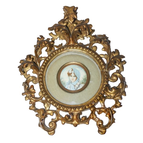 Miniature female figure with gilded wooden scroll frame