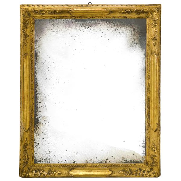 Mirror in a gilded and carved wooden frame with mercury mirror
