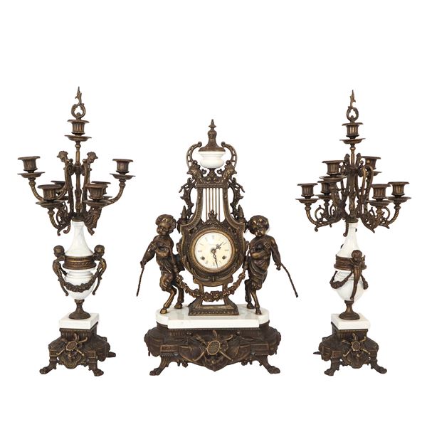 Triptych in gold patinated bronze and marble with imperial clock with two fauns on the sides and two Napoleon III candlesticks