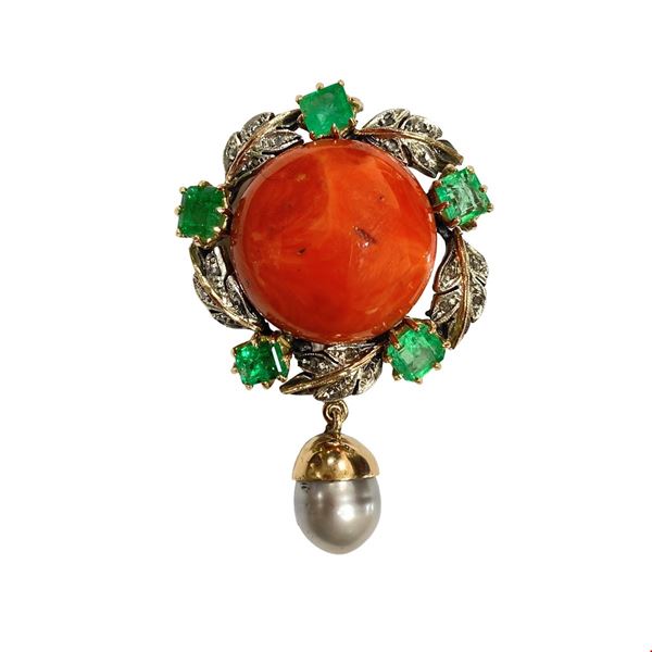 Gold brooch with red coral in the center, leaves with diamonds and five emeralds