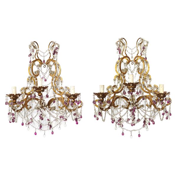 Pair of gilded metal appliques with three-light glass spheres and white and amethyst flowers