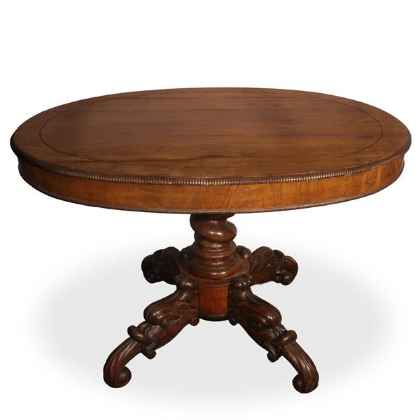 Round oak table with serrated edge top and 4-star base