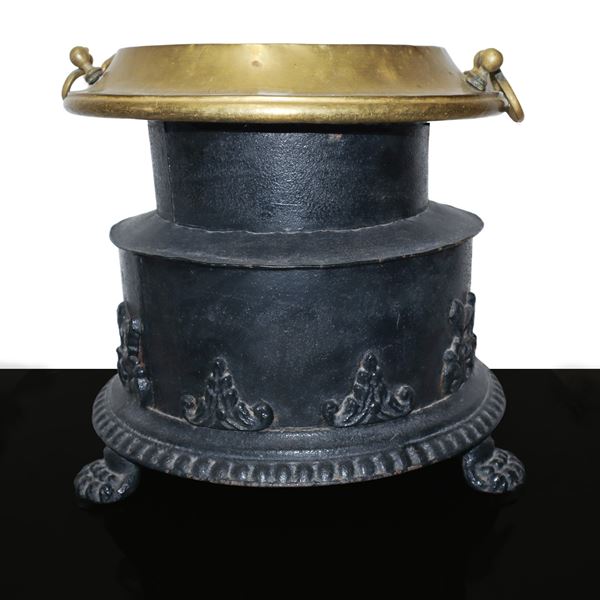 Wrought iron brazier with gilded brass upper part with relief decorations and lion feet