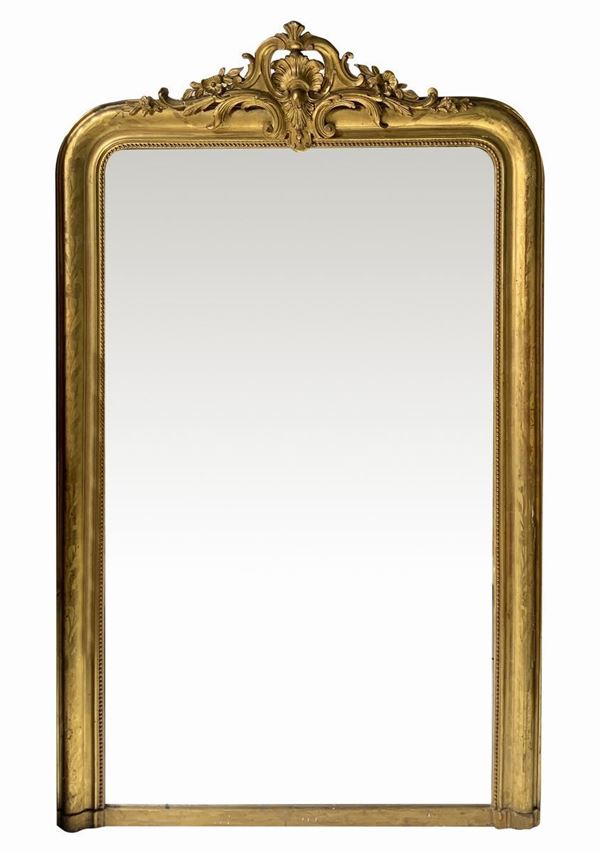 Mantelpiece mirror in gilded wood and molding in the lead, France nineteenth century. 180x112 cm