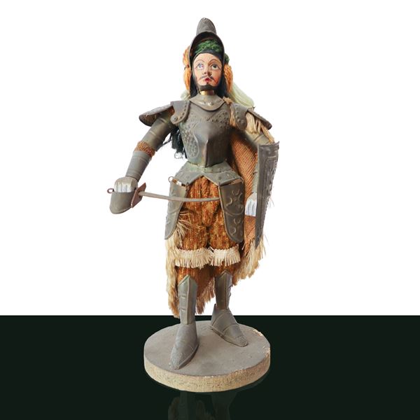 Sicilian puppet with cloth dress and embossed metal armor and wooden base