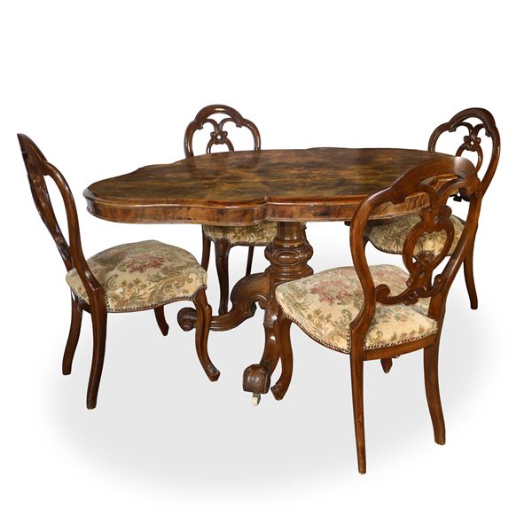 Biscuit table with walnut root top and 4-star base with casters with 5 chairs in floral fabric and walnut wood