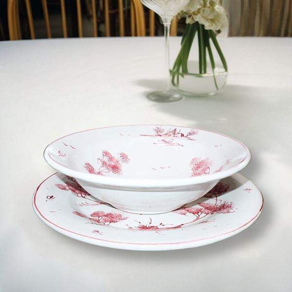 Set of 12 white ceramic plates with pink-toned characters. 
