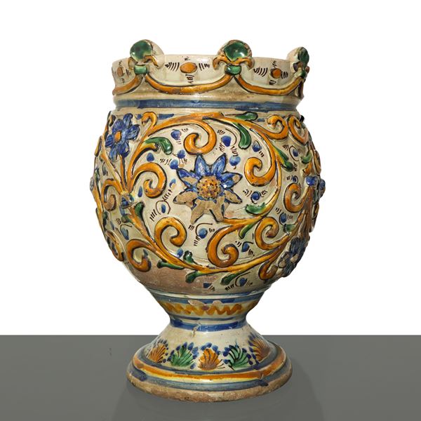 Caltagirone majolica tower cup with plastic decoration in yellow, blue and green on a white background