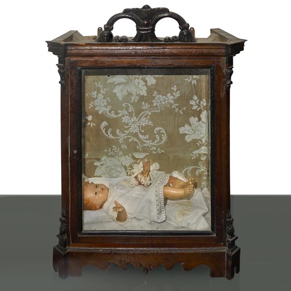 Baby Jesus in wax model contained in a wooden case