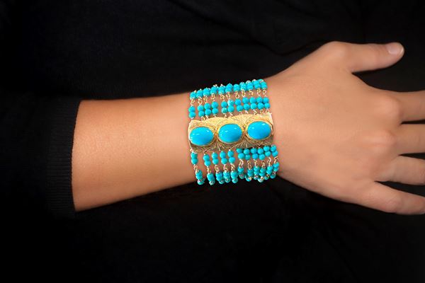 925 silver band bracelet with 11 strands of turquoise beads interspersed with three bands with turquoise medallions and safety clasp