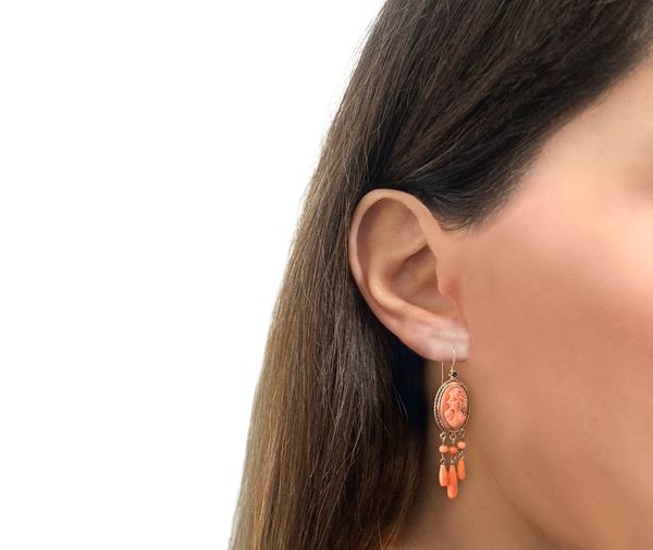 14kt yellow gold earrings with coral cameos within medallions and pendant corals and sapphire on the top of the medallions