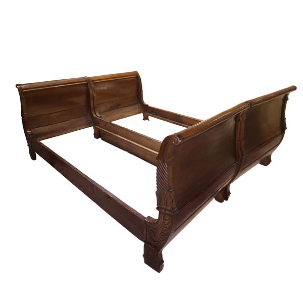 Pair of Charles X beds in walnut with carved headboards and footboards on the sides 