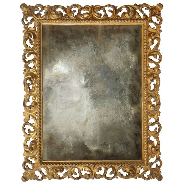 Specchiera con cornice in legno scolpito e traforato dorato a foglia e specchio coevo