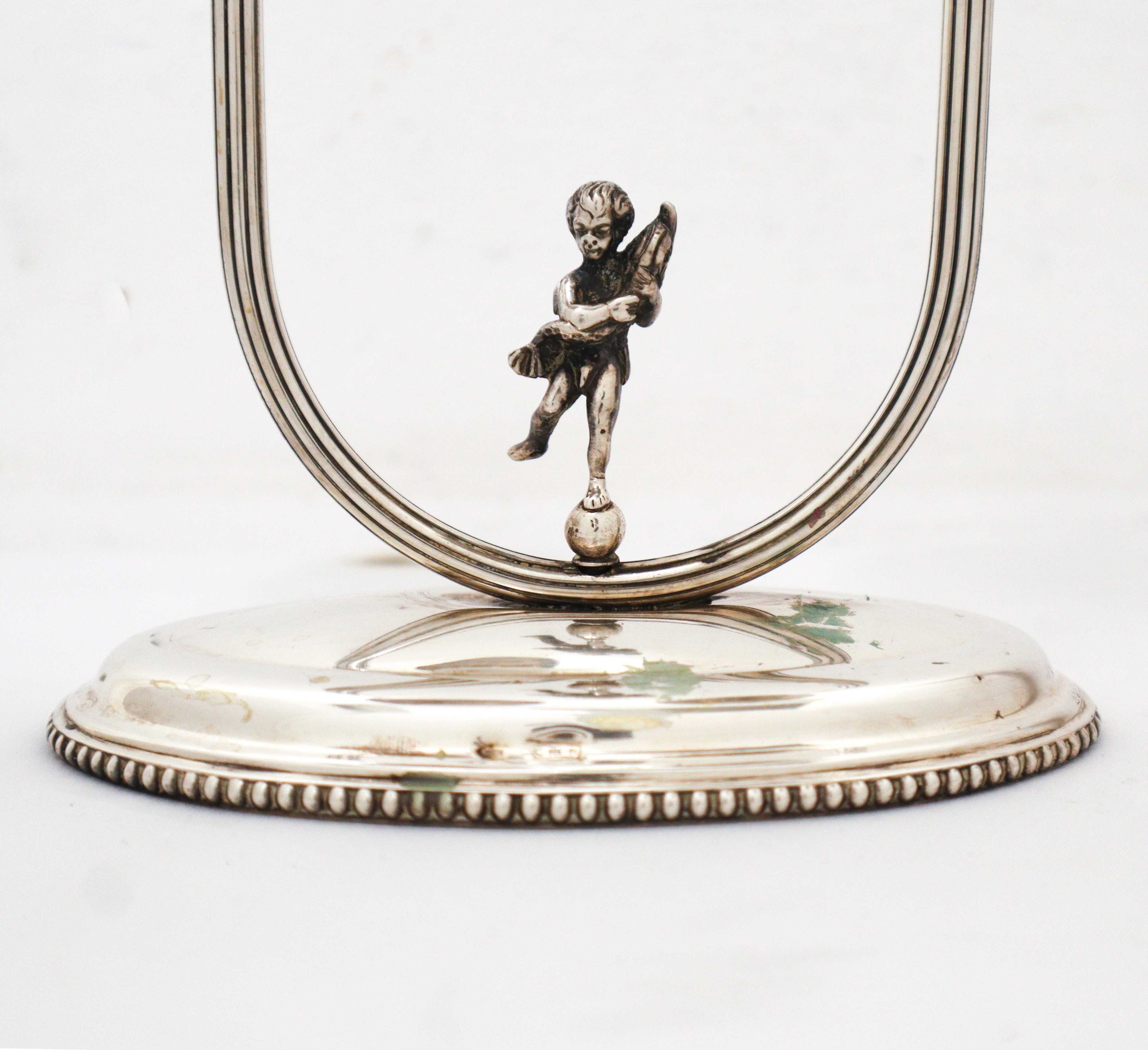 Coppia di candelabri a due fiamme in argento 800 con puttino sulla base