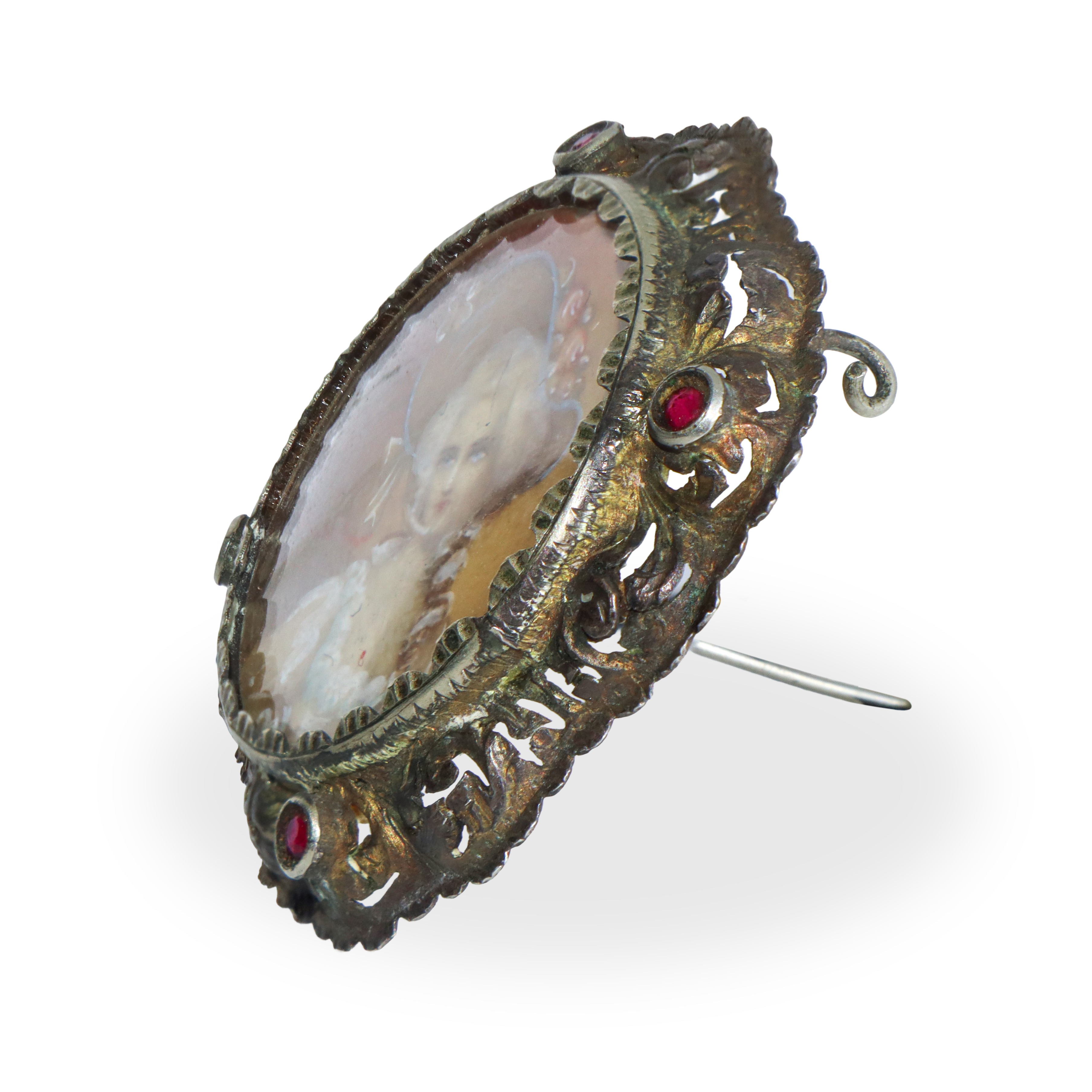 Spilla in argento con miniatura con bordo in filigrana con pietre granatine