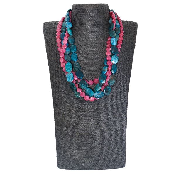 Four-strand necklace composed of two apatite strands and two cherry quartz rondelle strands with a silver clasp.