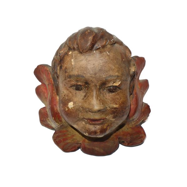 Testa di zefiro scolpita e intagliata in legno e dipinta policroma