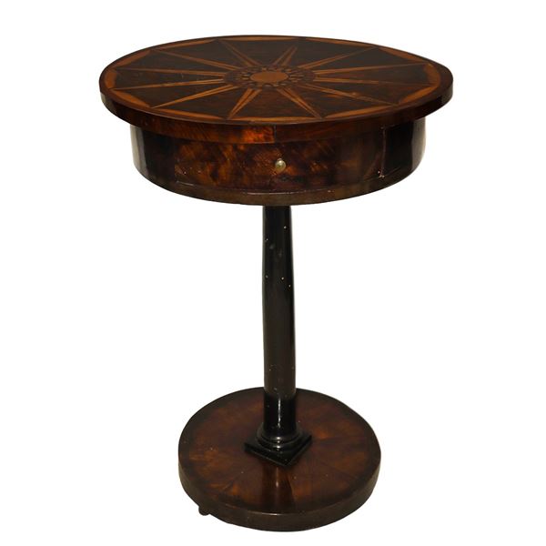 Small round wooden table with inlaid top in light wood and central drawer