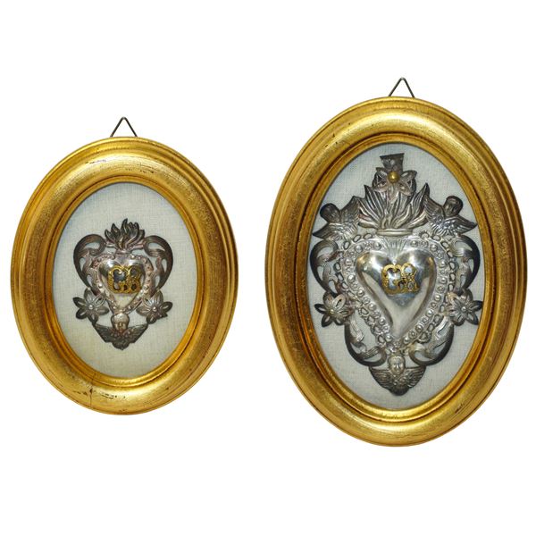 Pair of silver Ex Votos in a golden oval frame