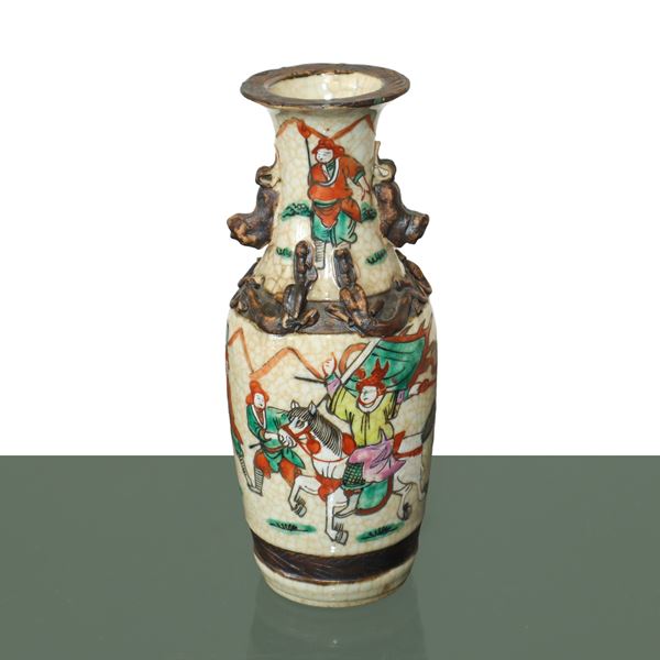 Chinese polychrome painted vase with scenes of warriors in battle and relief decorations