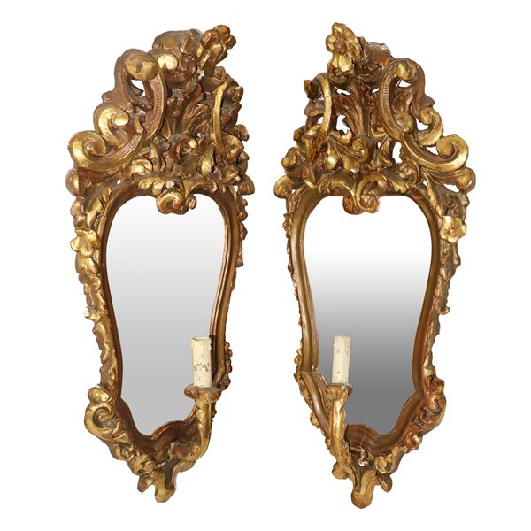 Pair of mirrors in gilded frames with candle holders