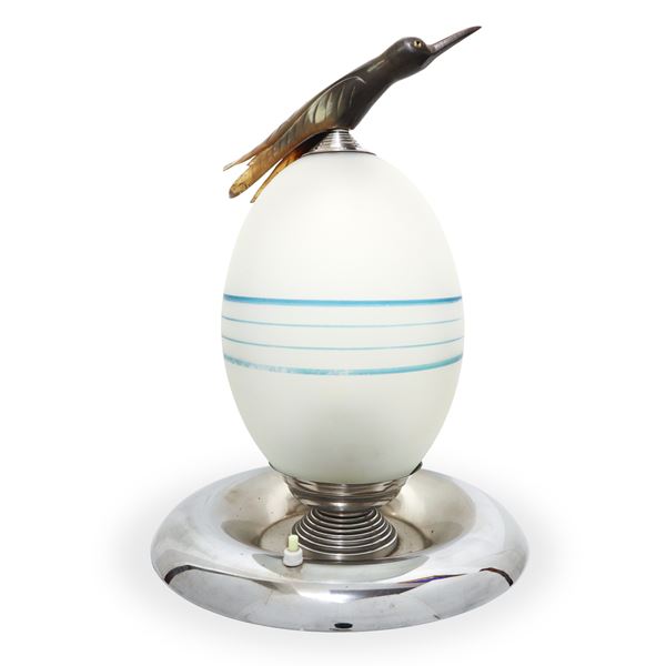 Table lamp with egg-shaped structure and bird on the top