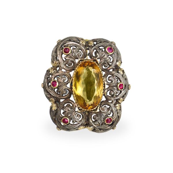Brooch in low-grade gold and silver with rubies and central topaz