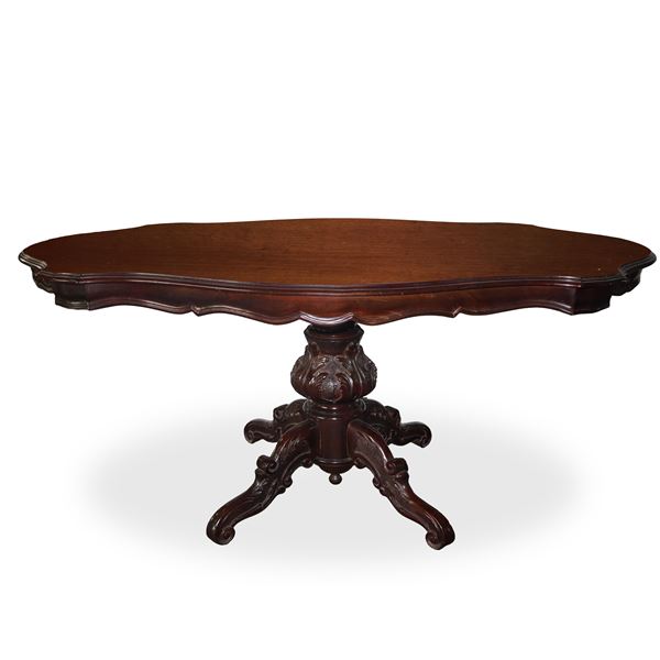 Wooden biscuit table with shaped top and 4-spoke carved and sculpted base