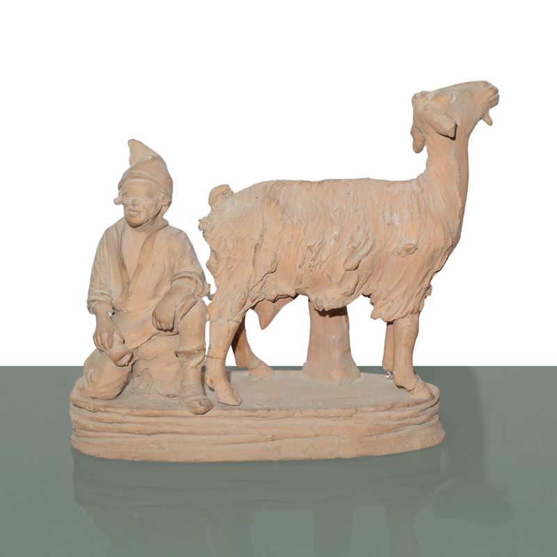 Pastore che munge una capra