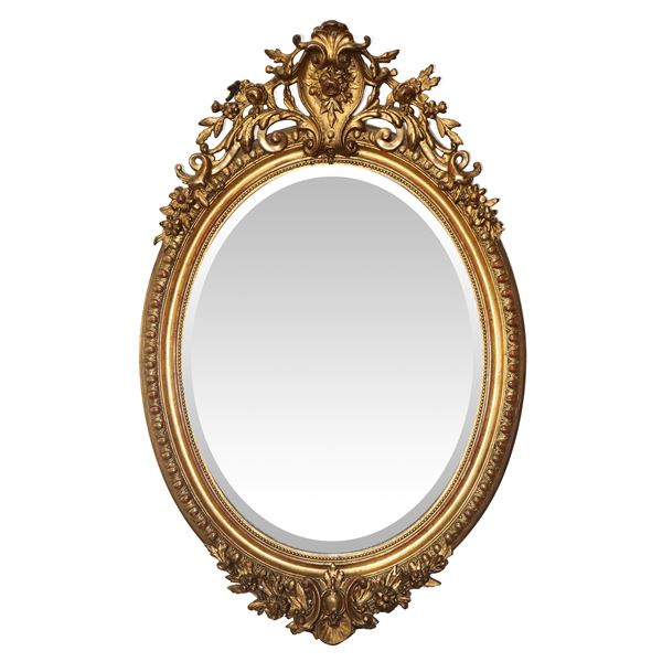 Specchiera francese ovale in cornice dorata in pastiglia con cimasa