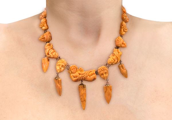 Antique Sciacca salmon coral and 375 gold necklace with sculptures of Bacchus, grapes, amphorae, and  [..]