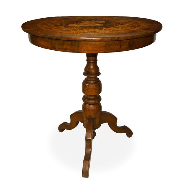 Round walnut table with three-spoke base and top inlaid with geometric motifs in contrasting light woods with a depiction of St. Michael the Archangel in the center