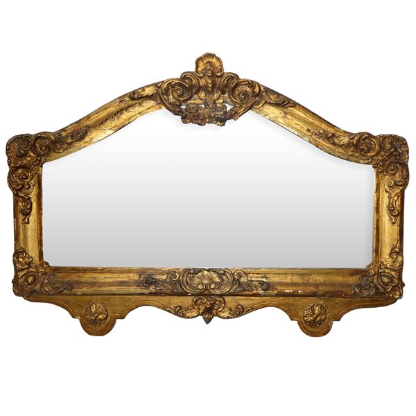 Gilded wooden mirror in a decorated frame