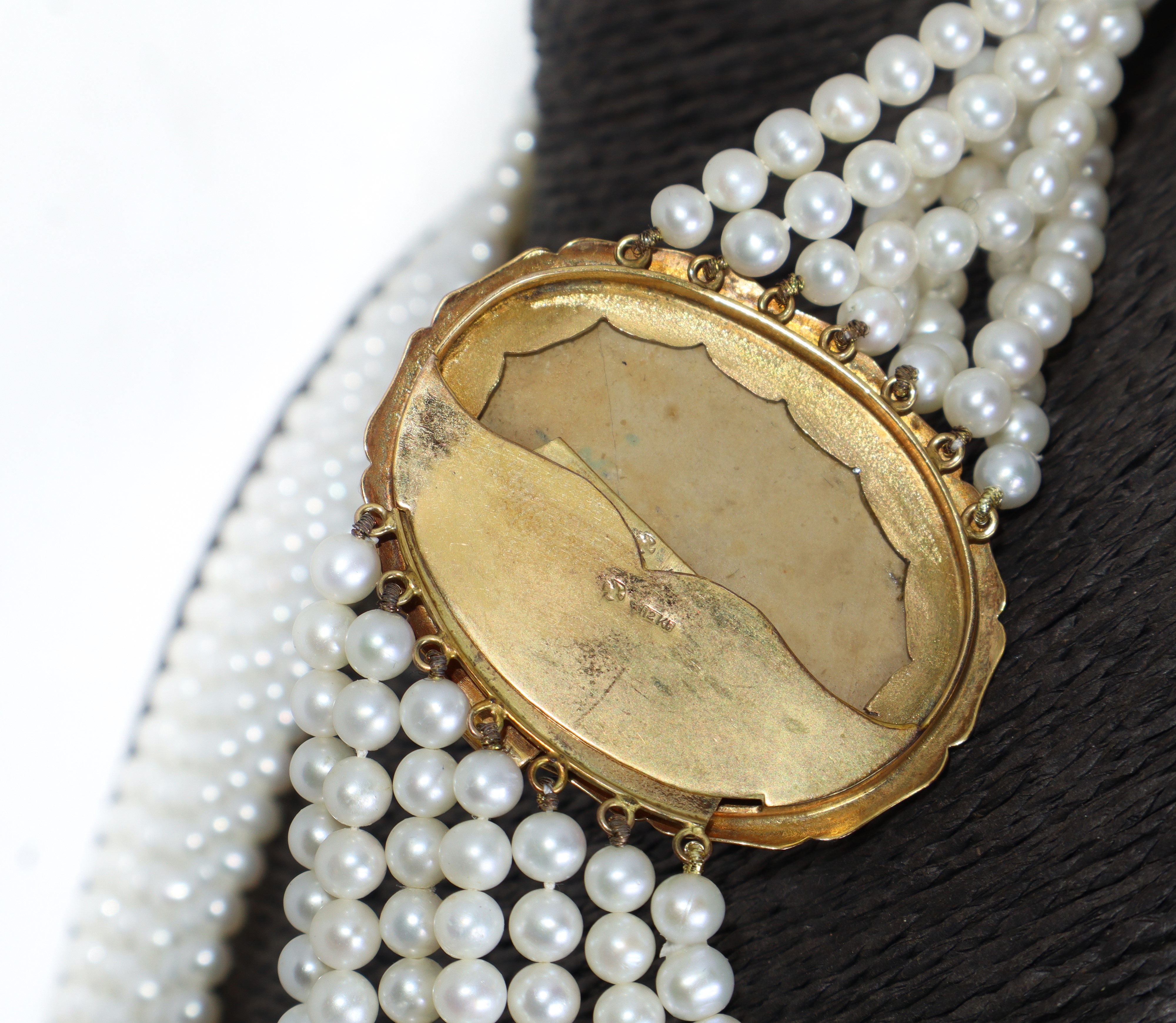 Collana in perle con ciondolo in oro basso titolo in pietra sintetica raffigurante due putti